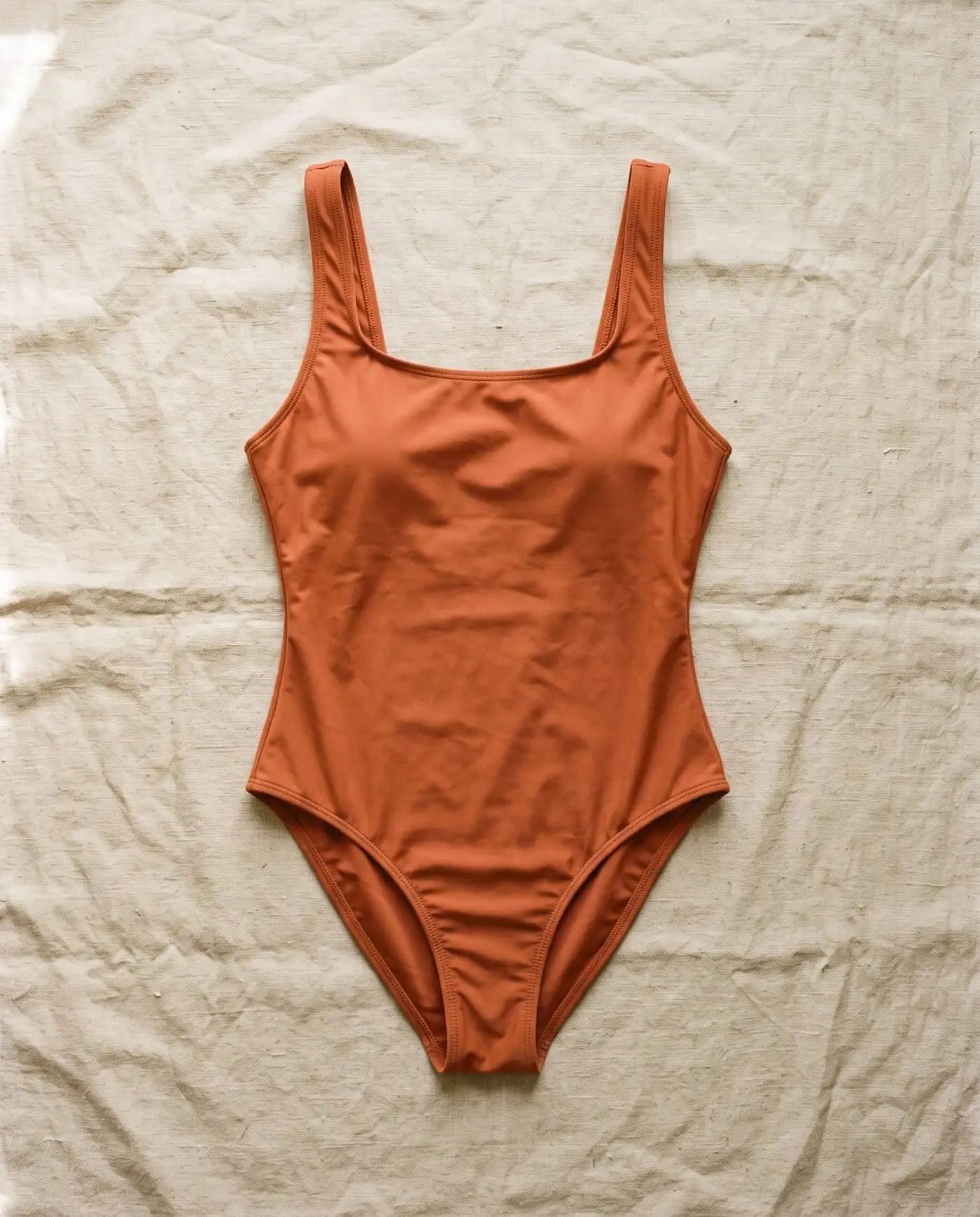 Clarkes high-leg one-piece in Ochre laid flat on sand-coloured linen